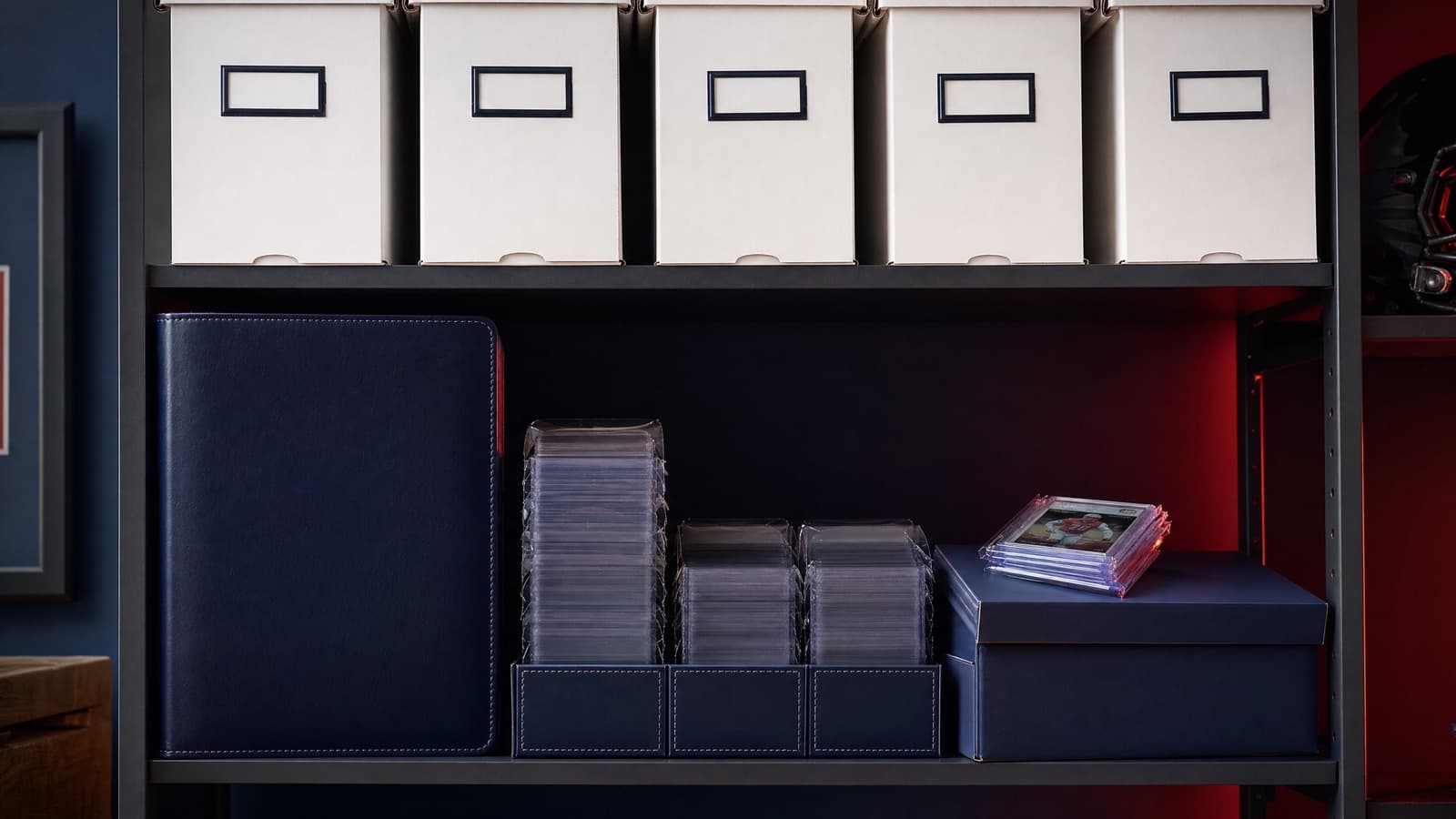 Organized card storage boxes, a binder, and top loaders on a shelf — how to store sports cards