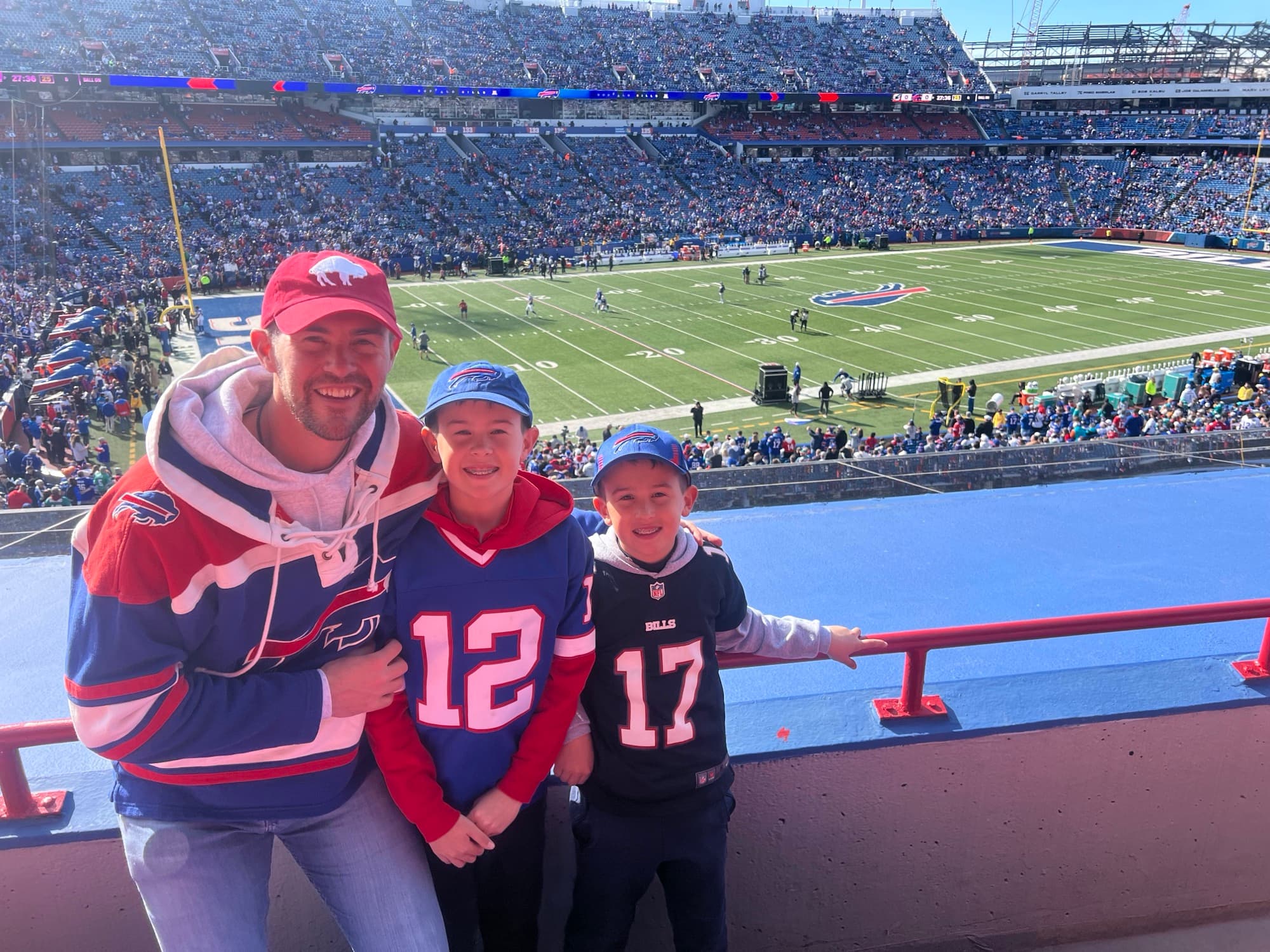 Ryan Hanley with his sons Duke and Colton at a Buffalo Bills game — the Badass Breaks crew